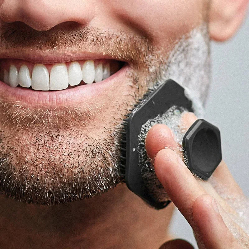 Men's silicone facial cleansing brush in use before shaving
