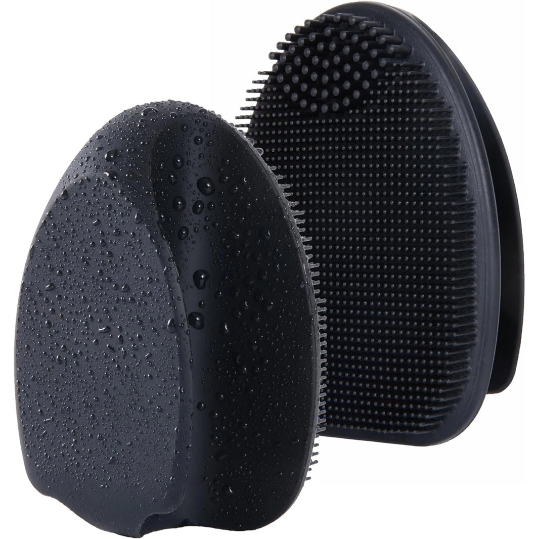 Silicone exfoliating facial brush held in hand for scale