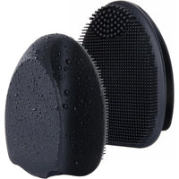 Silicone exfoliating facial brush held in hand for scale